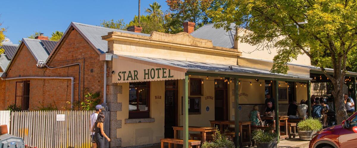 A Star Hotel with outdoor seating and a bar/lounge area.