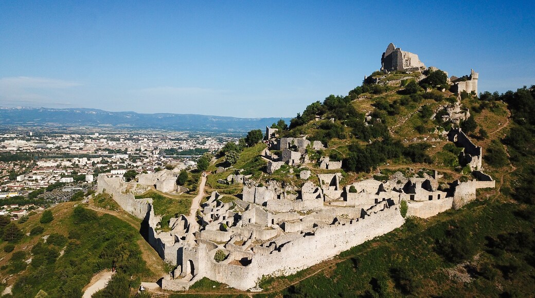 Aerial view of the medieval ruins of Chateau de Crussol on a limestone ridge overlooking the Rhone valley in Saint-Peray, Auvergne-Rhone-Alpes, France.