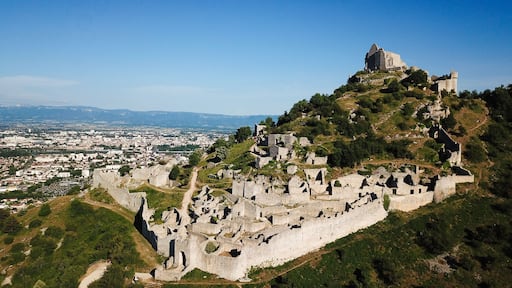 Aerial view of the medieval ruins of Chateau de Crussol on a limestone ridge overlooking the Rhone valley in Saint-Peray, Auvergne-Rhone-Alpes, France.
