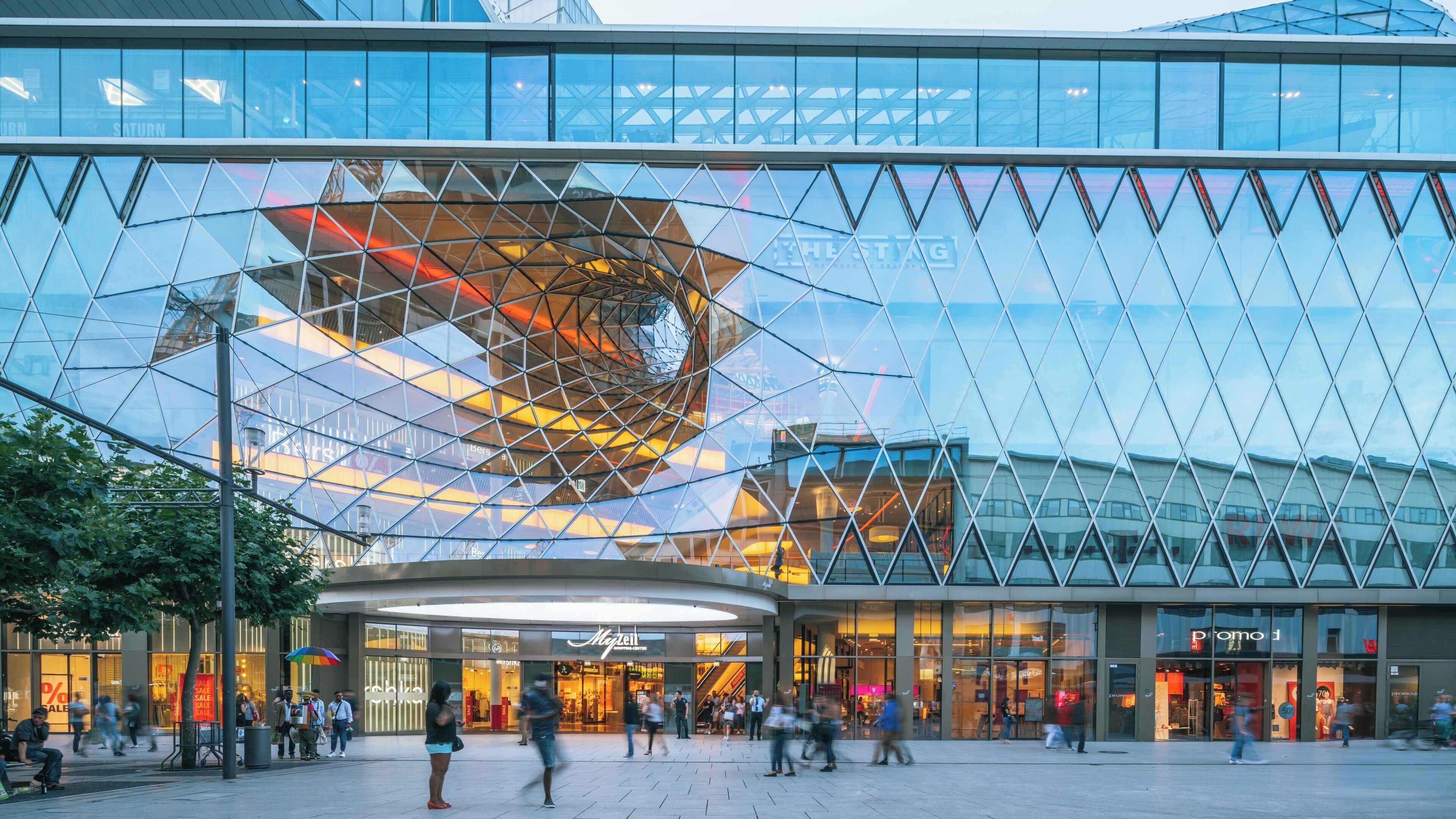 MyZeil shopping center in Frankfurt showcases stunning architecture and vibrant atmosphere during evening hours