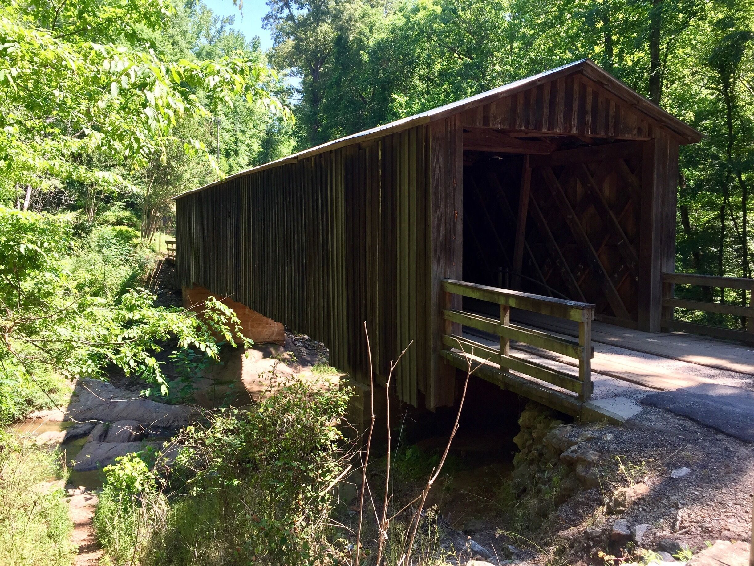 Originally built in 1897 this bridge was moved here in 1924 to support a grist mill that was here. It is one of only a handful of covered bridges in Georgia that are still in use. 