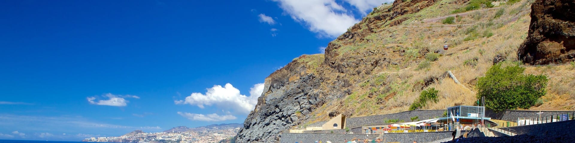 Reis Magos Beach which includes landscape views, a pebble beach and general coastal views