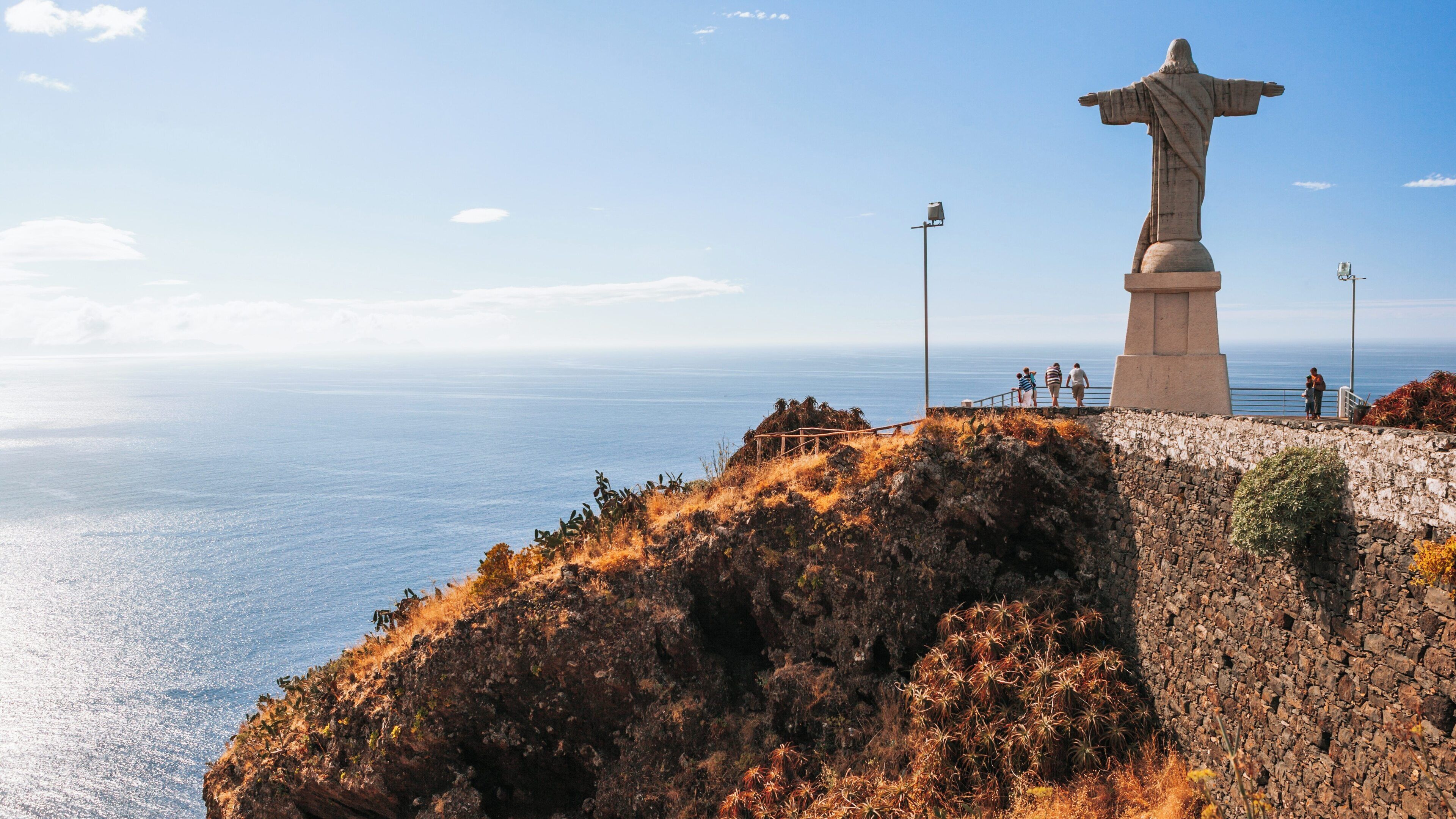 Exploring Ponta da Oliveira in Santa Cruz, Madeira with the Christ the Redeemer statue overlooking the ocean