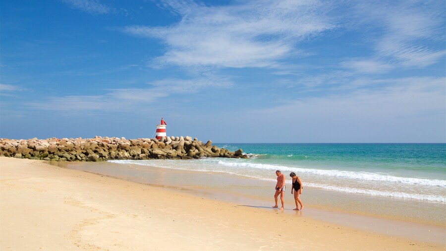Ilha de Tavira Beach which includes a sandy beach, rugged coastline and general coastal views