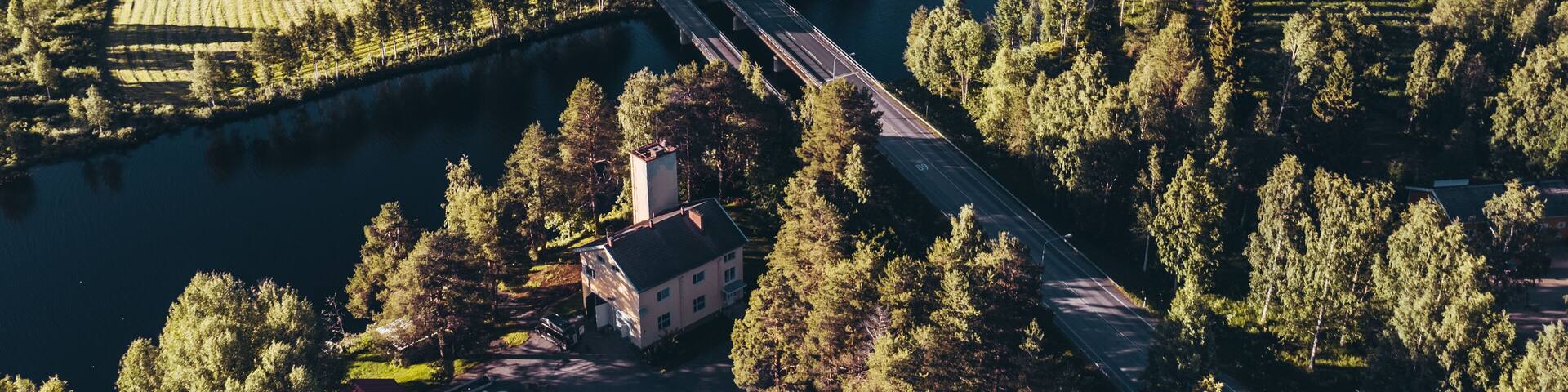 Bridge over water at Hyrynsalmi Finland with sunshine