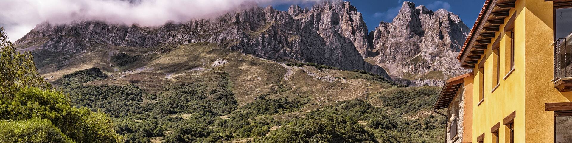 A mountain range with a building in the foreground.
