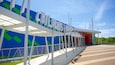 A modern building with a blue and green mural and the words "CHILDREN'S MUSEUM" on the facade.