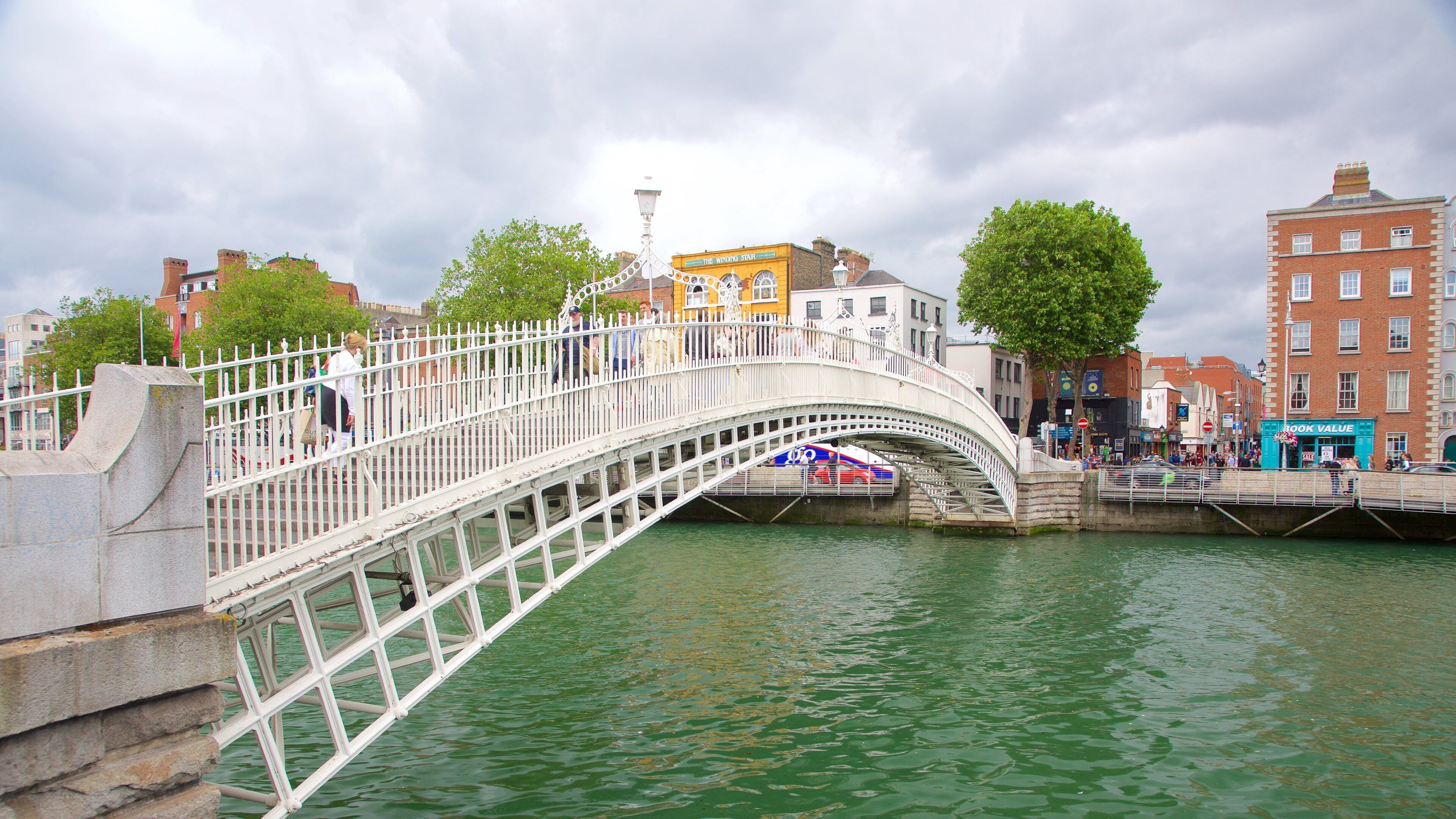Ha\' Penny Bridge showing a bridge, a city and a river or creek