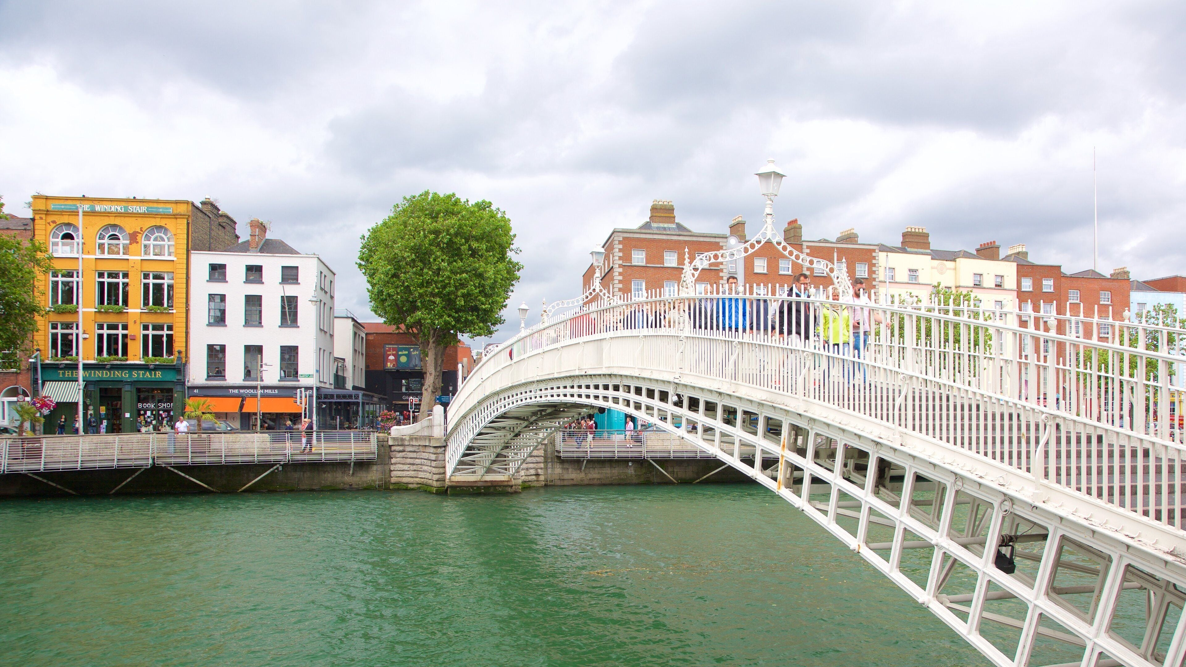 Ha\' Penny Bridge showing a city, a bridge and a river or creek