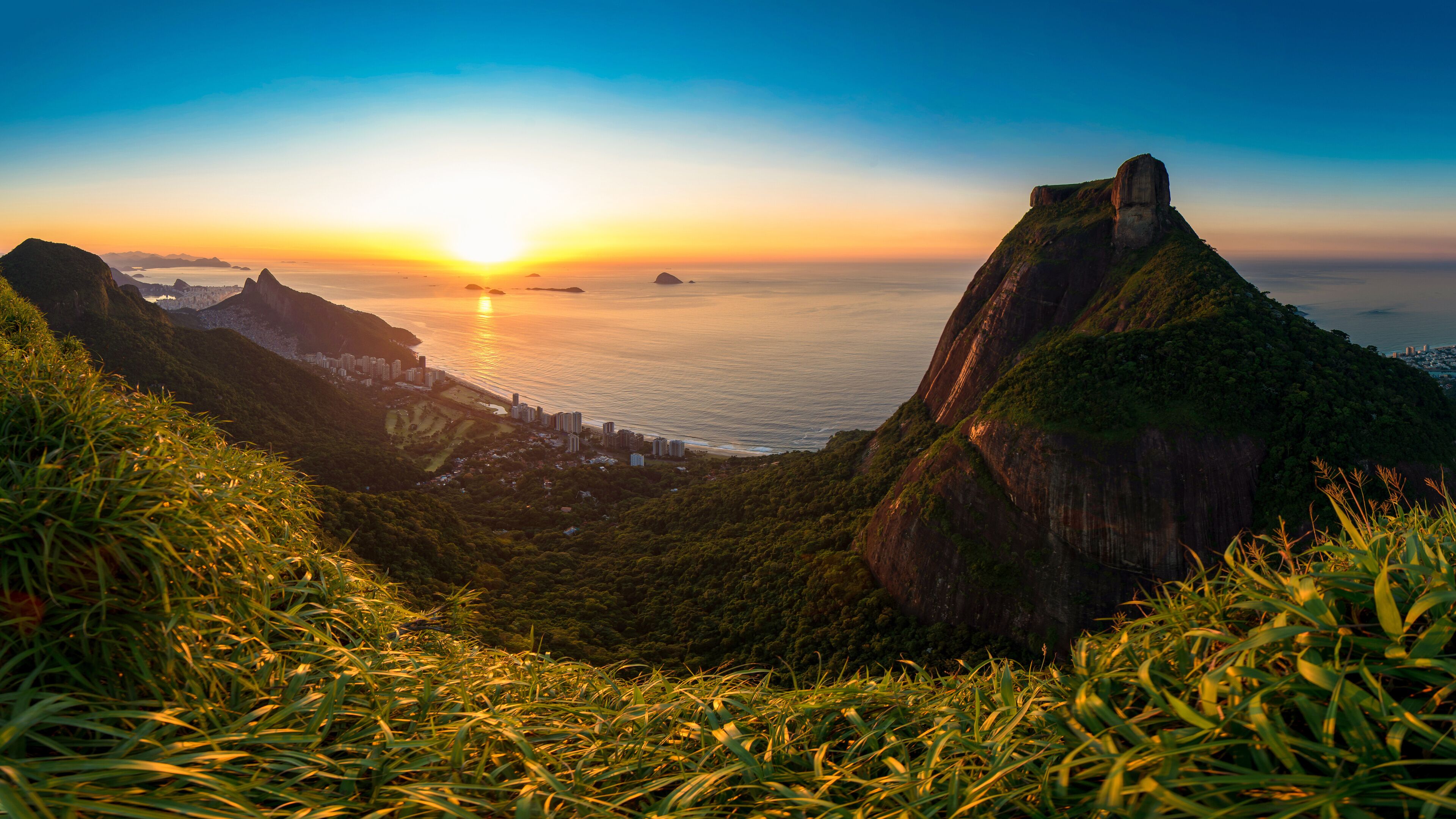 Scenic Panoramic View of Sunrise in Rio de Janeiro City, Pedra da Gavea, Sao Conrado Beach, and Two Brothers Mountain With Favela Rocinha