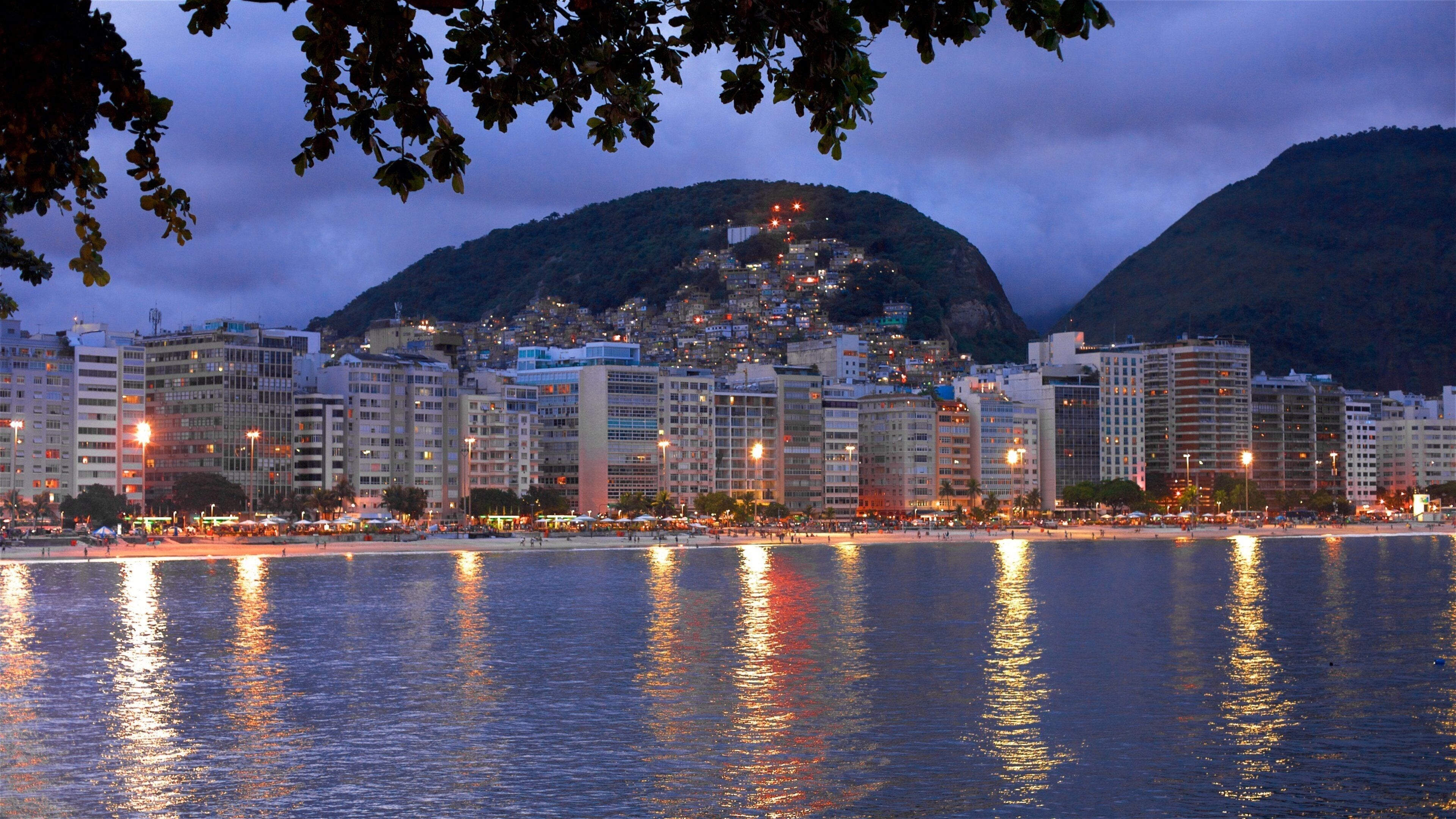 Copacabana Fort which includes night scenes, general coastal views and a city