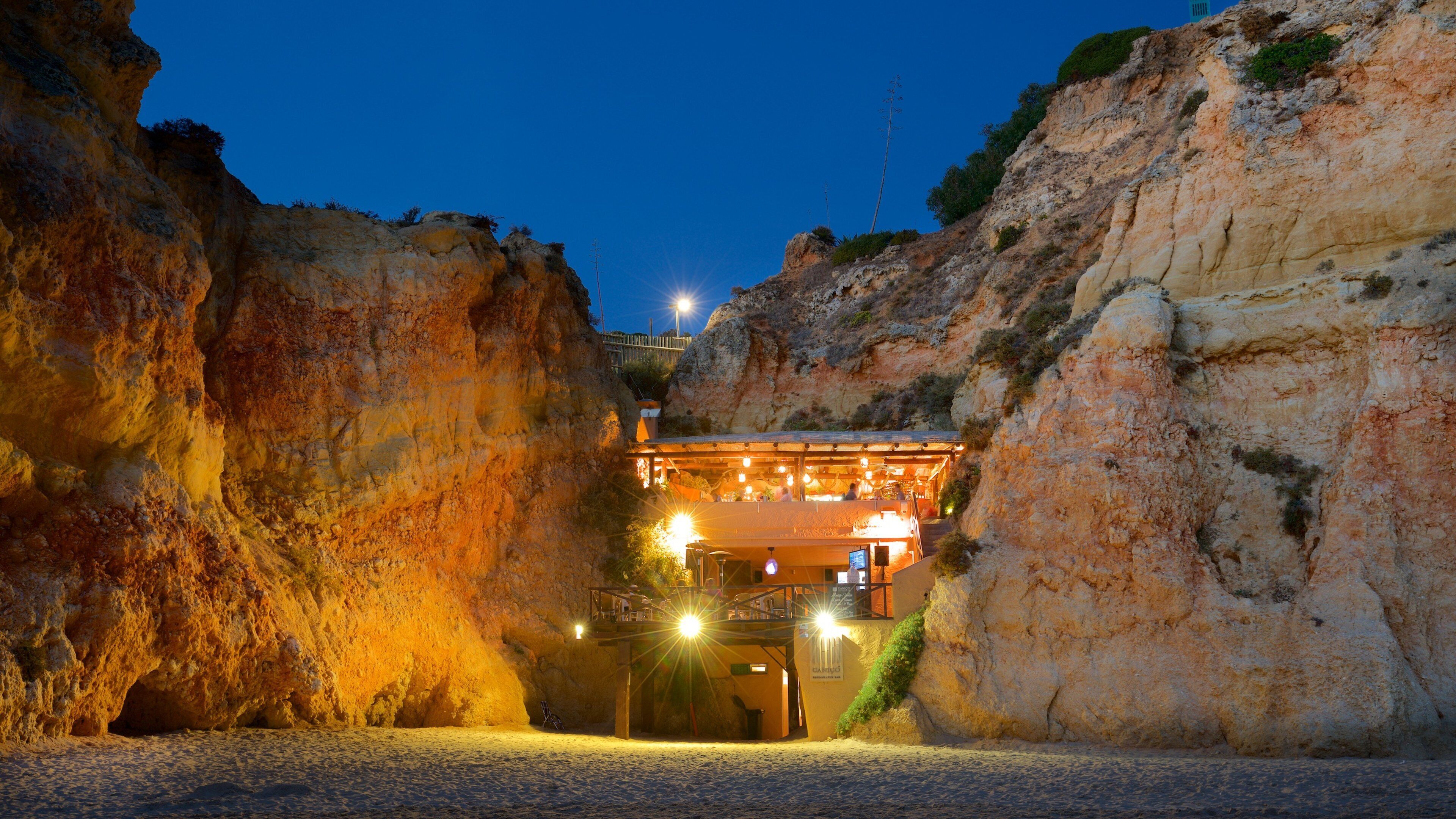 Tres Irmaos Beach which includes a beach, rocky coastline and night scenes