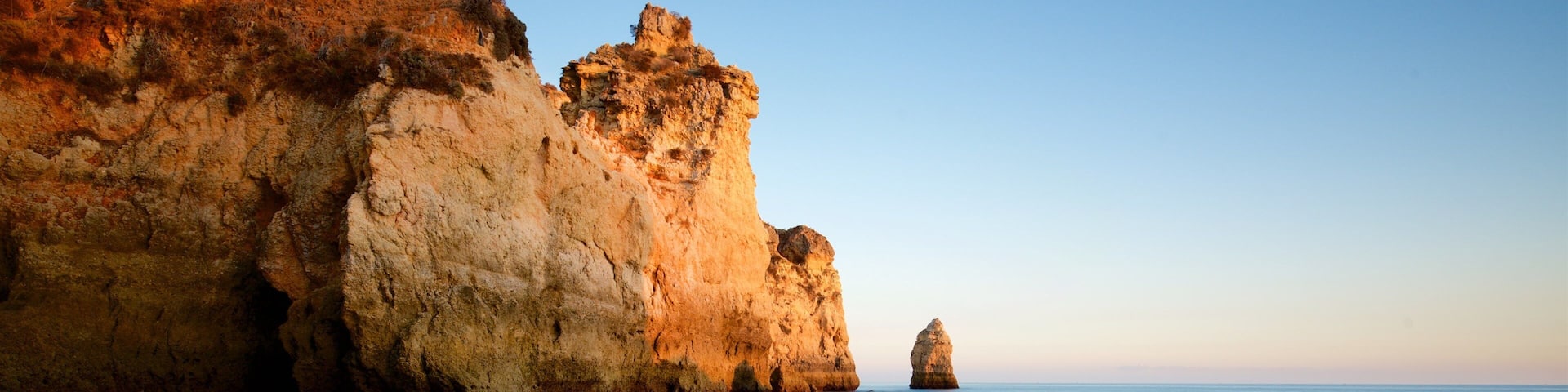 Tres Irmaos Beach featuring a sunset, rocky coastline and general coastal views