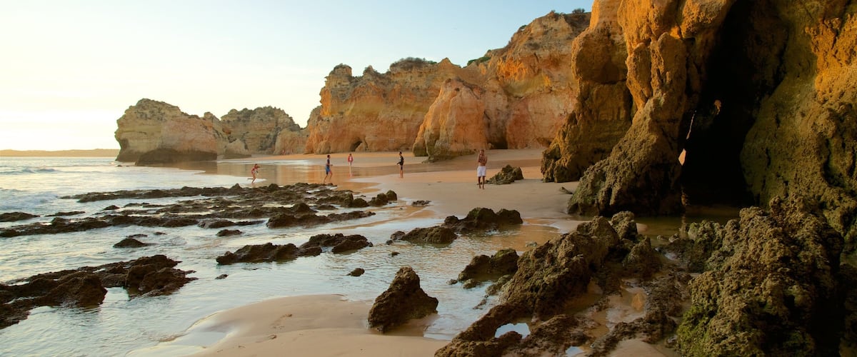 Tres Irmaos Beach showing a sunset, general coastal views and a sandy beach