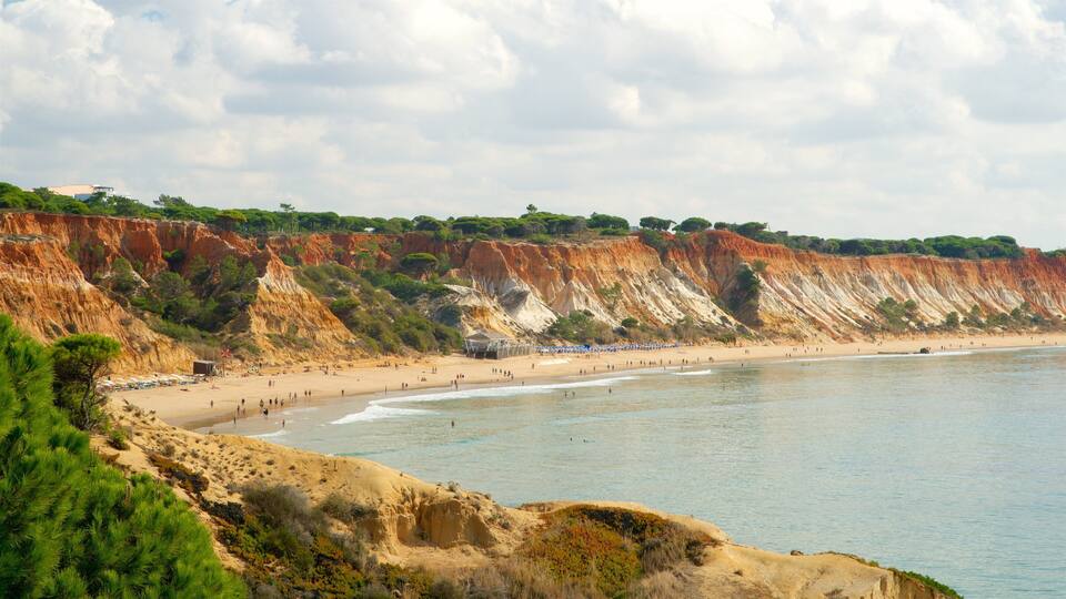 A coastal landscape with cliffs, beach, and umbrellas.