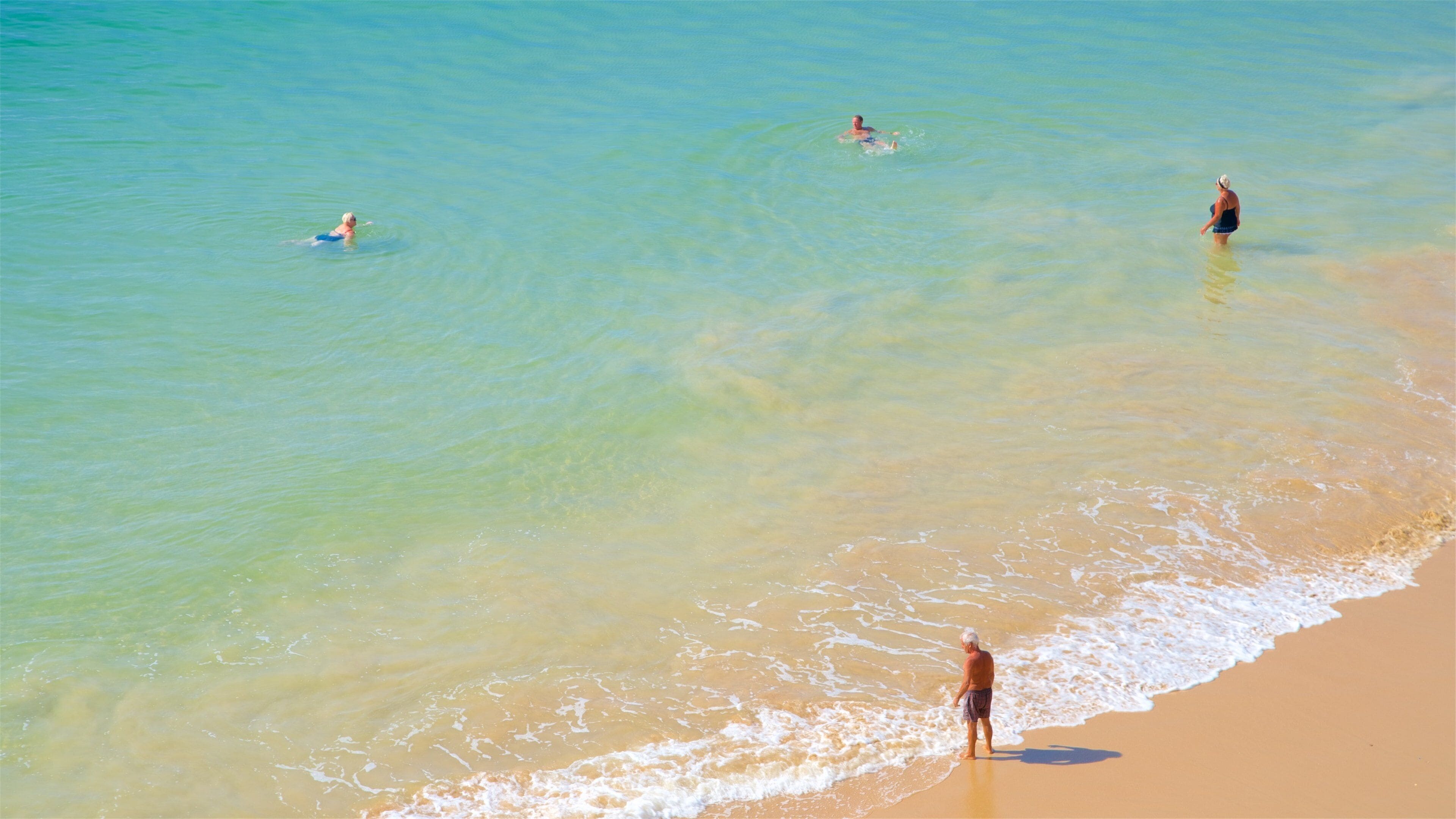 Praia dos Olhos de Água which includes swimming, general coastal views and a sandy beach