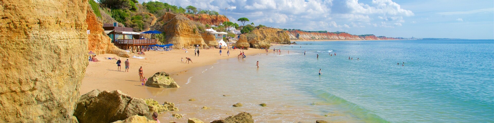 Olhos D\'Agua Beach showing a beach, general coastal views and rugged coastline