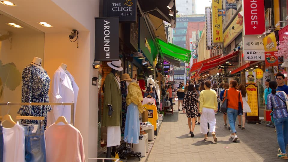 Myeongdong showing shopping as well as a small group of people