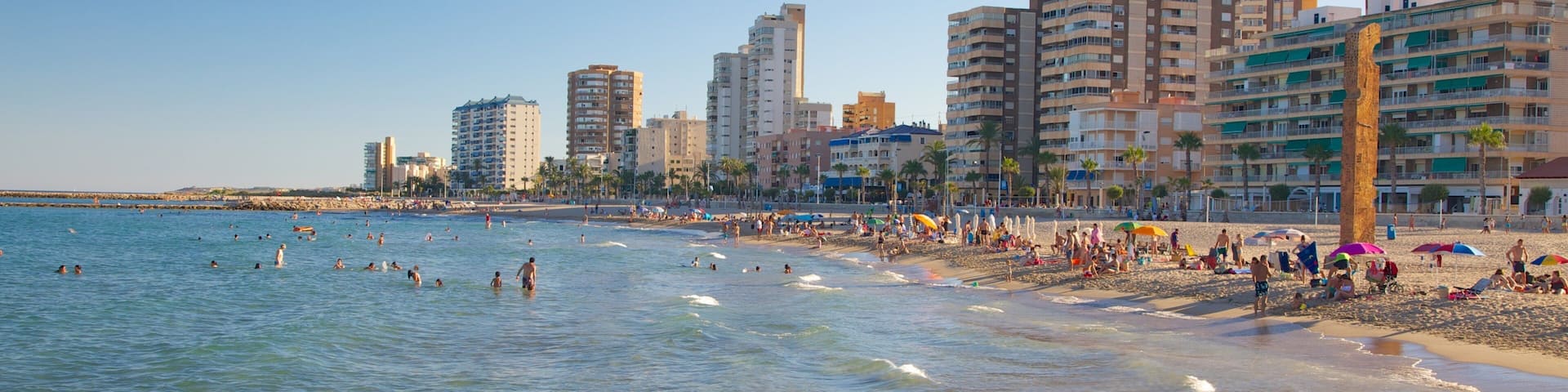 Campello Beach which includes swimming, a coastal town and a luxury hotel or resort
