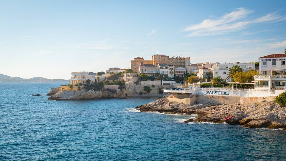 A coastal town with buildings on a rocky cliff overlooking the sea.