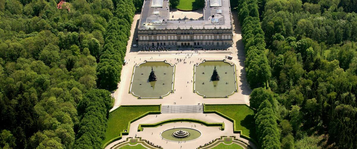 Herrenchiemsee New Palace which includes landscape views, heritage architecture and a park