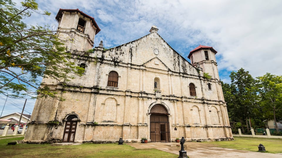 An old church with a bell tower and arched windows.