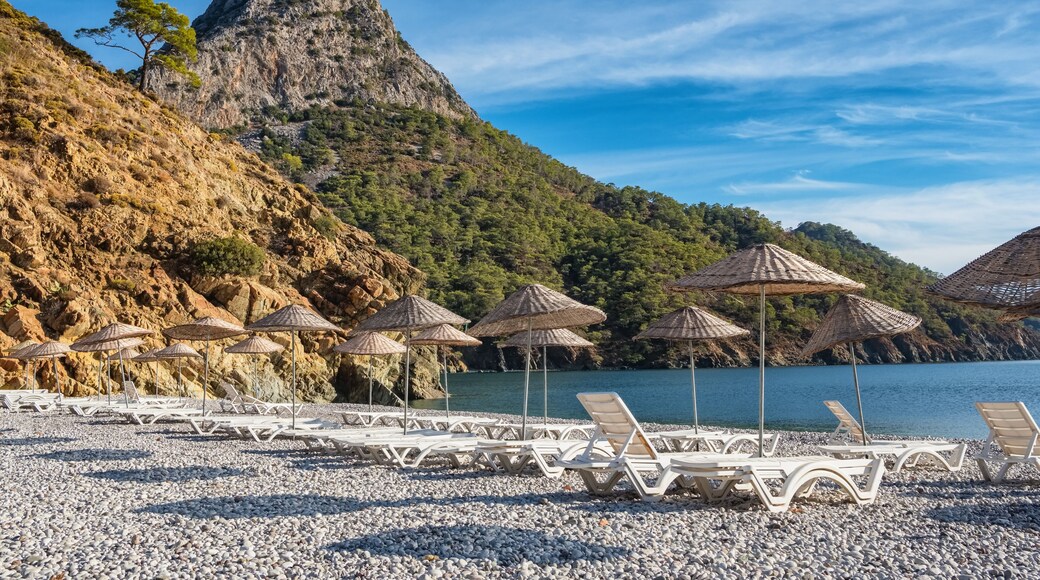 Beach umbrellas and sunbeds on the Adrasan beach in Turkey