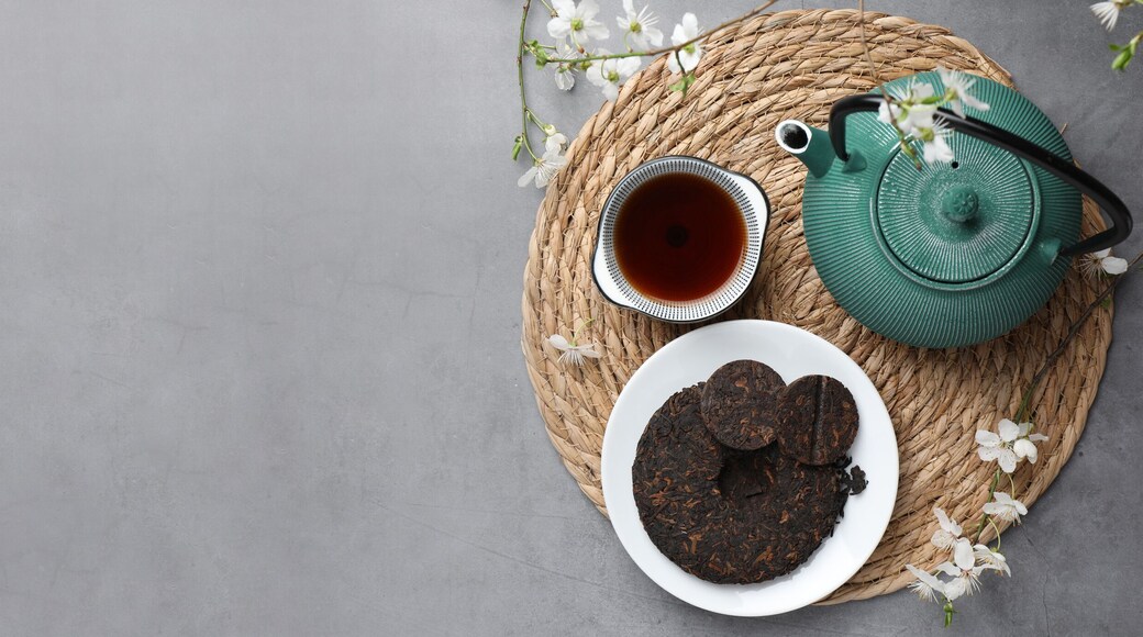 Aromatic pu-erh tea served on grey table, top view. Banner design with space for text
