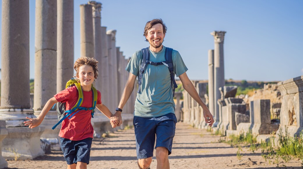 dad and son tourists at the ruins of ancient city of Perge near Antalya Turkey. Traveling with kids concept