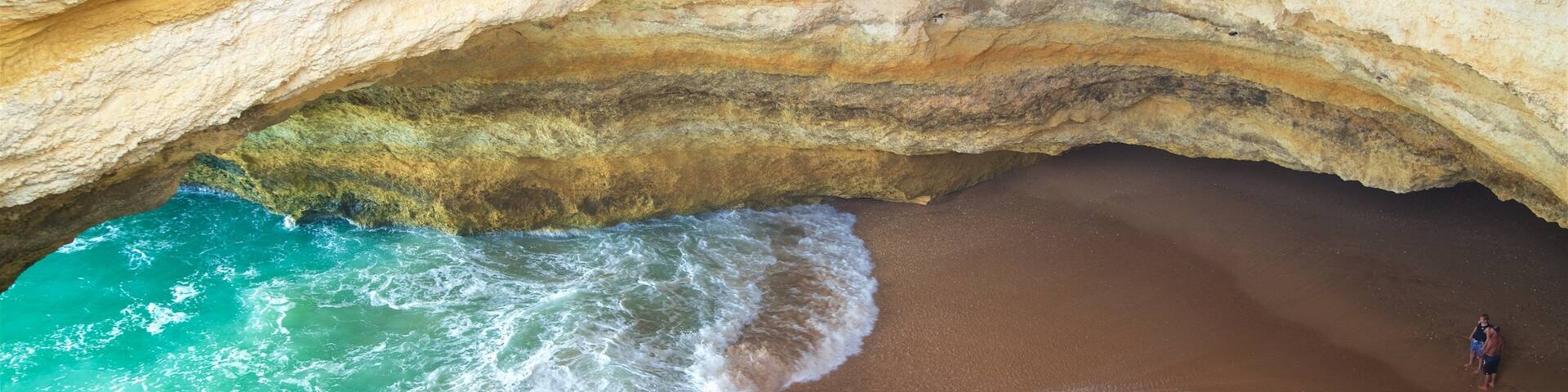 Benagil Beach which includes general coastal views, a sandy beach and rugged coastline