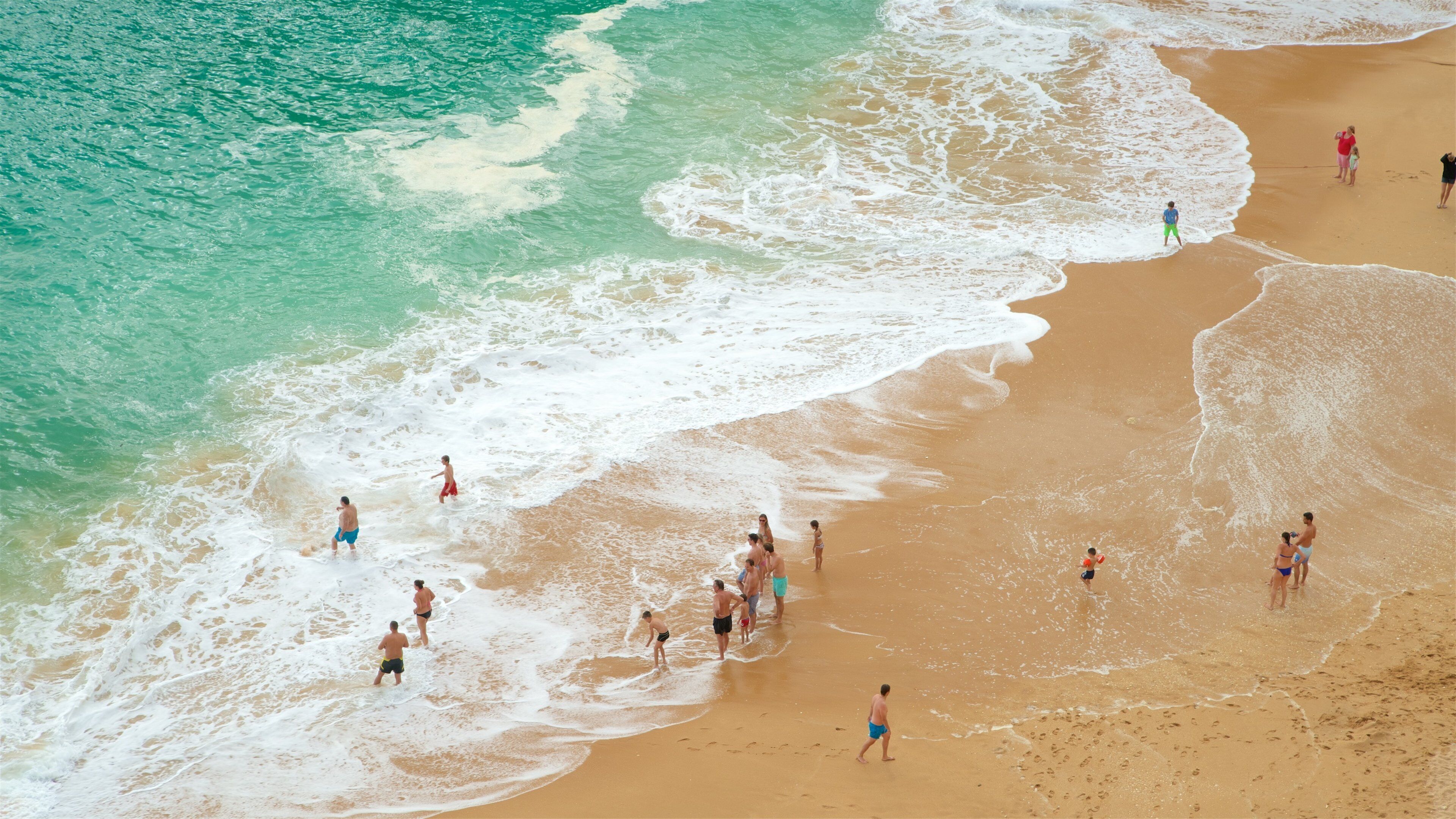 Benagil Beach featuring a beach and general coastal views as well as a small group of people