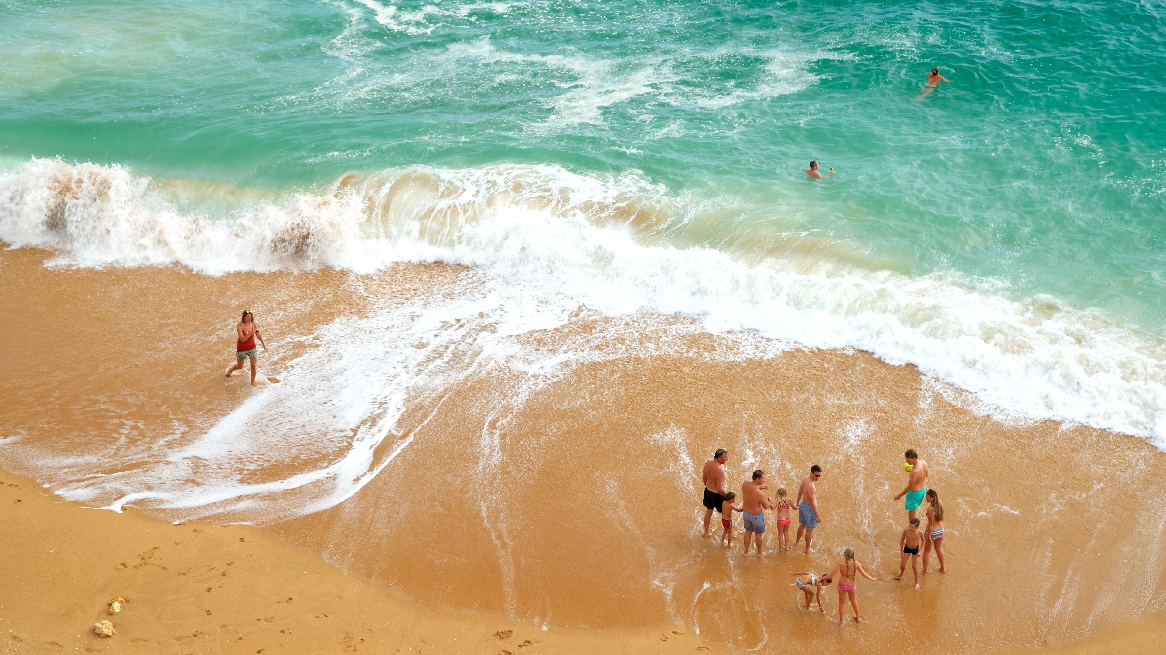 Benagil Beach showing general coastal views and a beach as well as a small group of people
