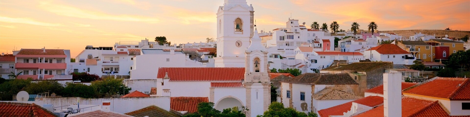 Santo Antonio Church featuring a sunset and a city