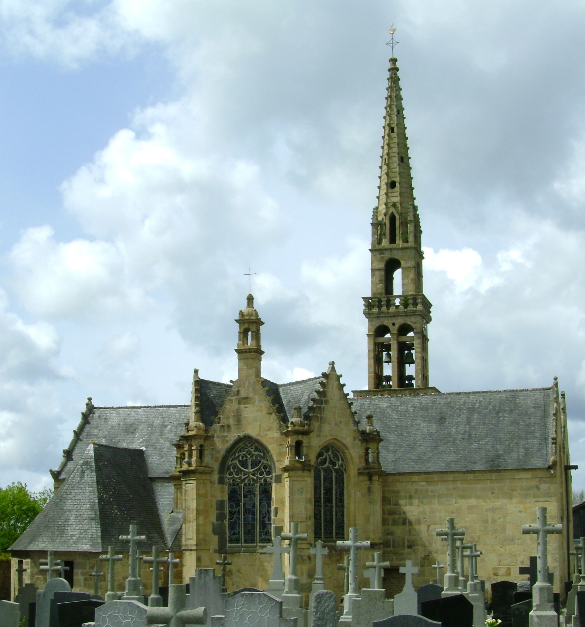 A Gothic church with a tall spire and a bell tower.