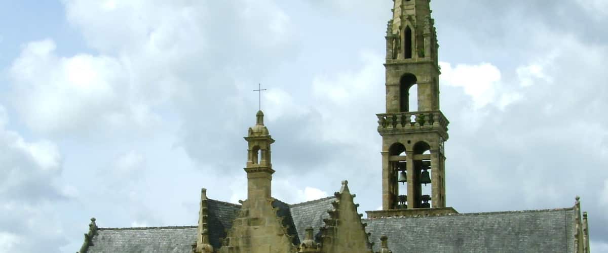 A Gothic church with a tall spire and a bell tower.