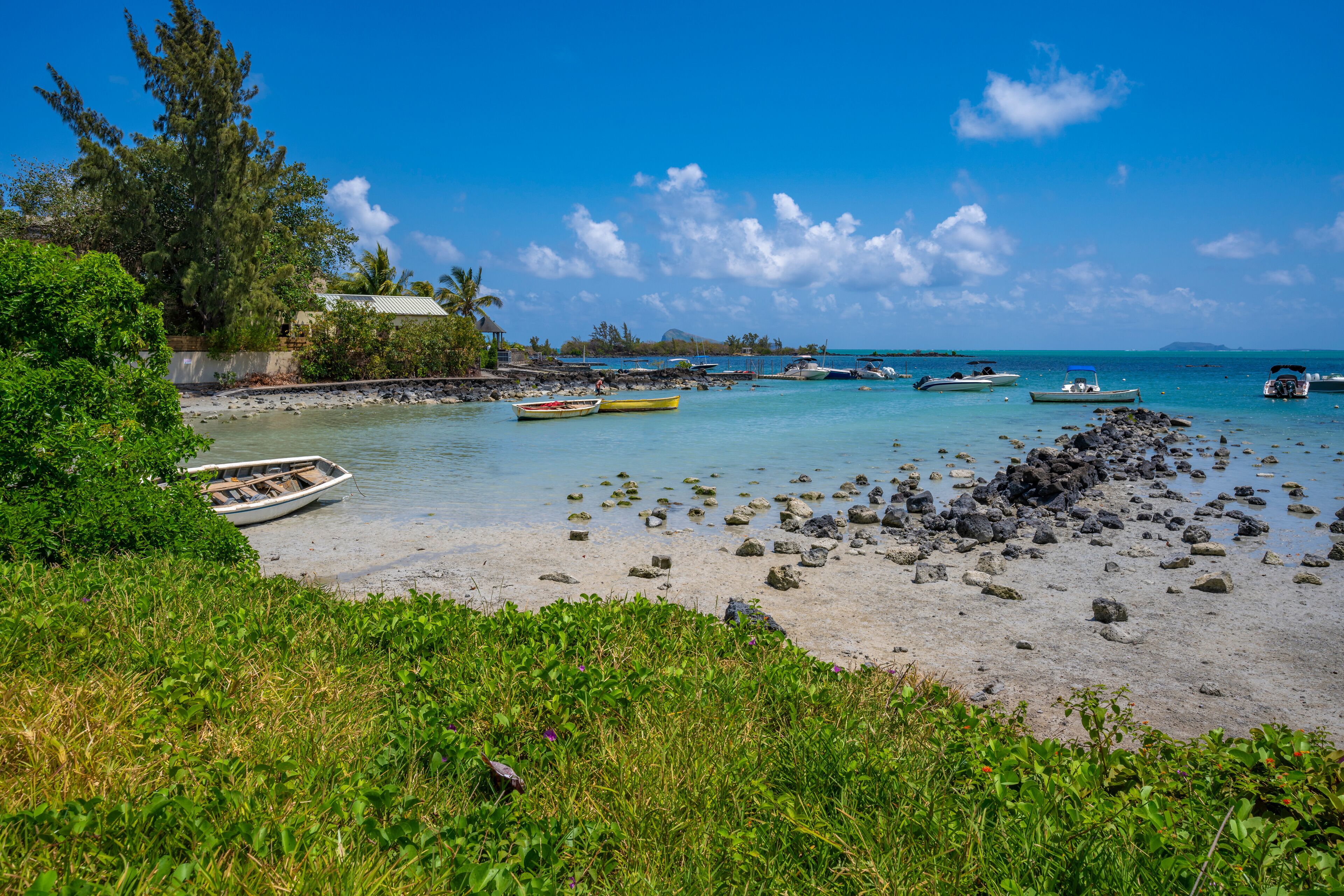 View of beach and turquoise Indian Ocean on sunny day near Poste Lafayette, Mauritius