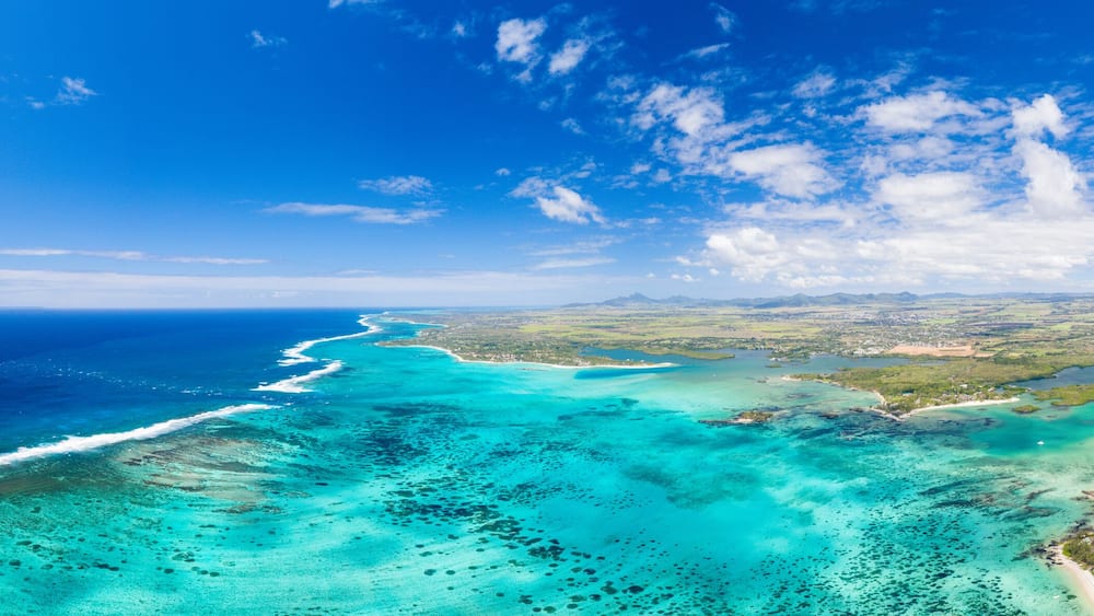 Turquoise coral reef meeting the waves of the Indian Ocean, aerial view, Poste Lafayette, East coast, Mauritius
