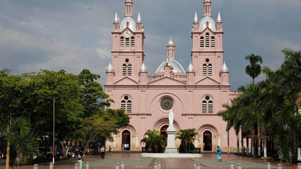 A large pink brick church with two towers and a central dome.