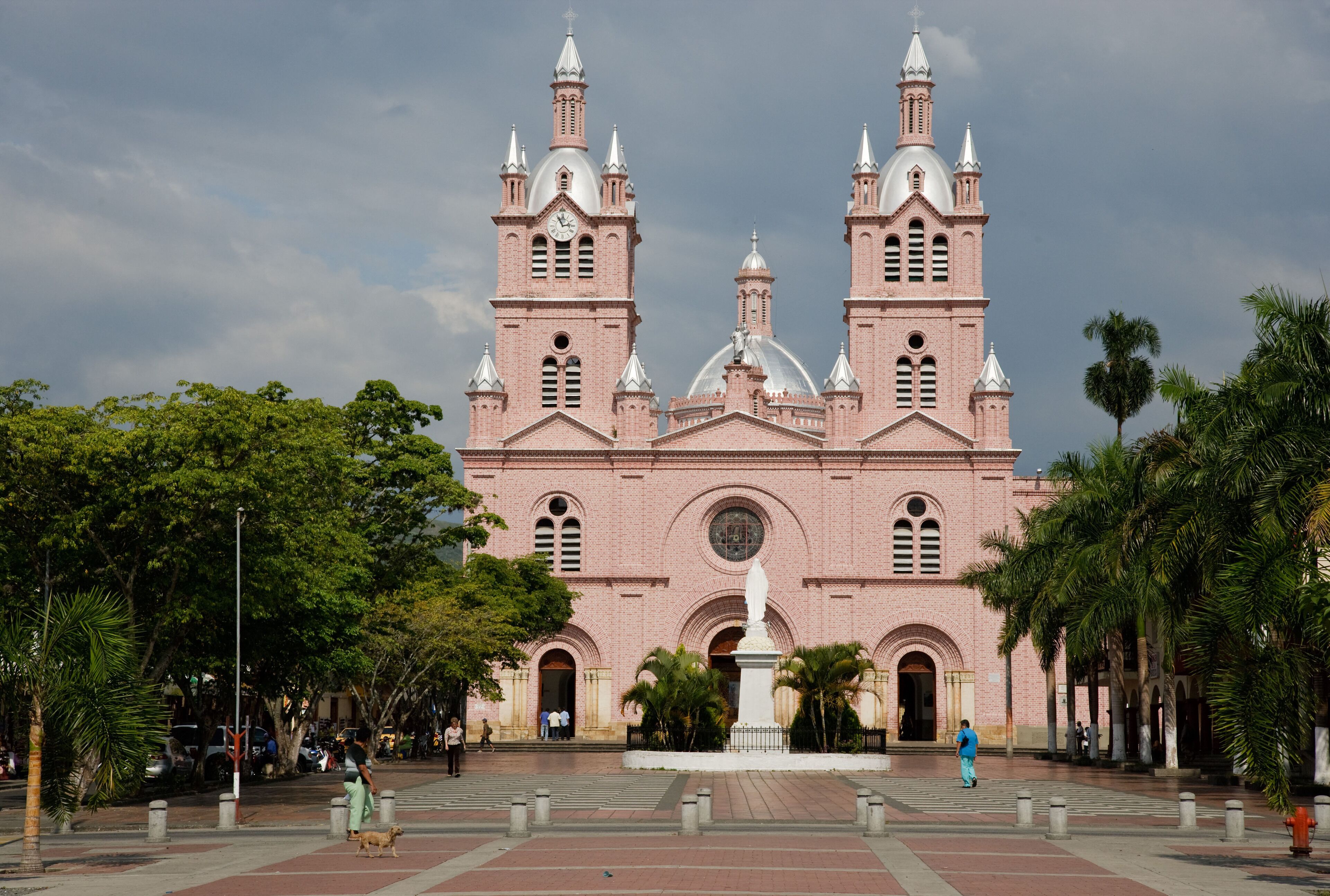 A large pink brick church with two towers and a central dome.