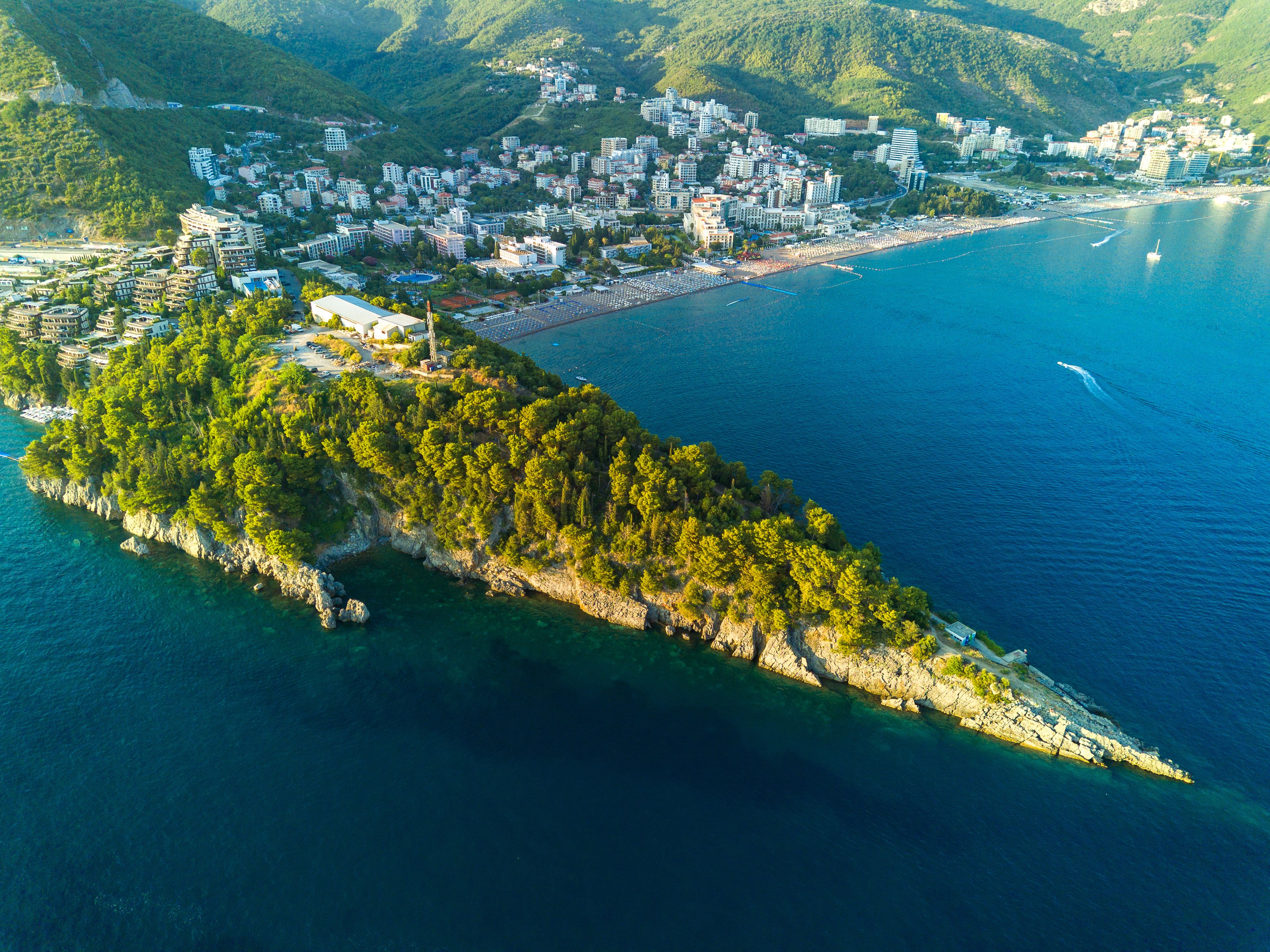 Bird's eye view of towns of Budva and Becici with hotels and beaches near Adriatic Sea against the backdrop of the Montenegrin Mountains