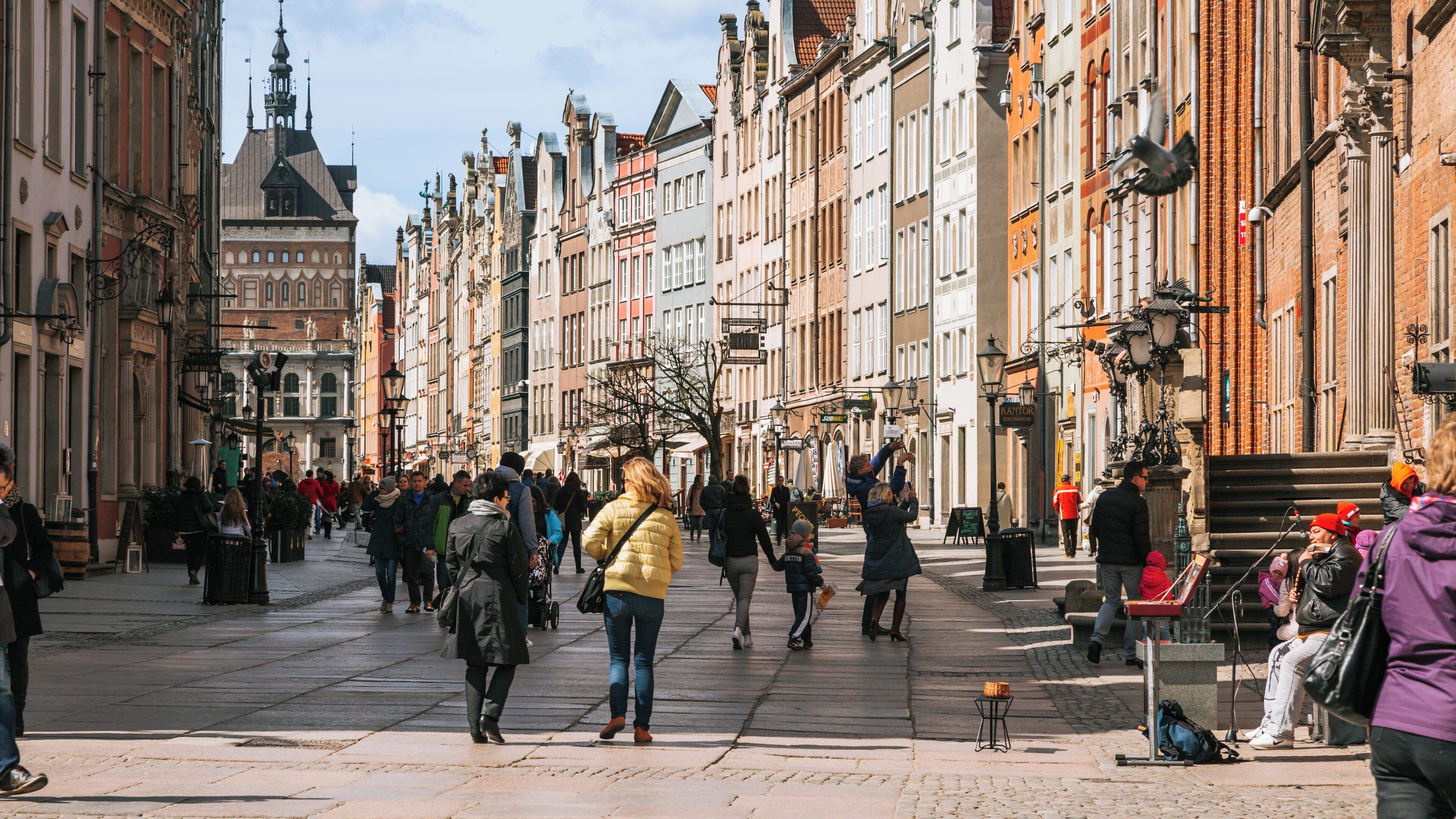 Vibrant atmosphere along Long Lane in Gdansk City Center with people strolling and historic architecture in sight