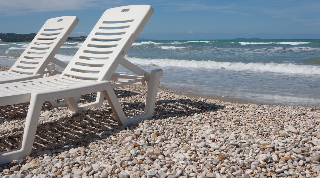 Deckchair at the beach of Acharavi Island of Corfu Greece. Waves at the coast. Mediterranean sea