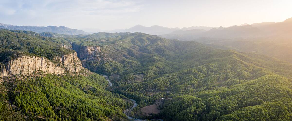 Morning landscape just after sunrise. The sun's rays fall on the mountain valley. Aerial view of Koprulu National Park near ancient city of Selge Adam Kayalar, Turkey. High resolution panorama