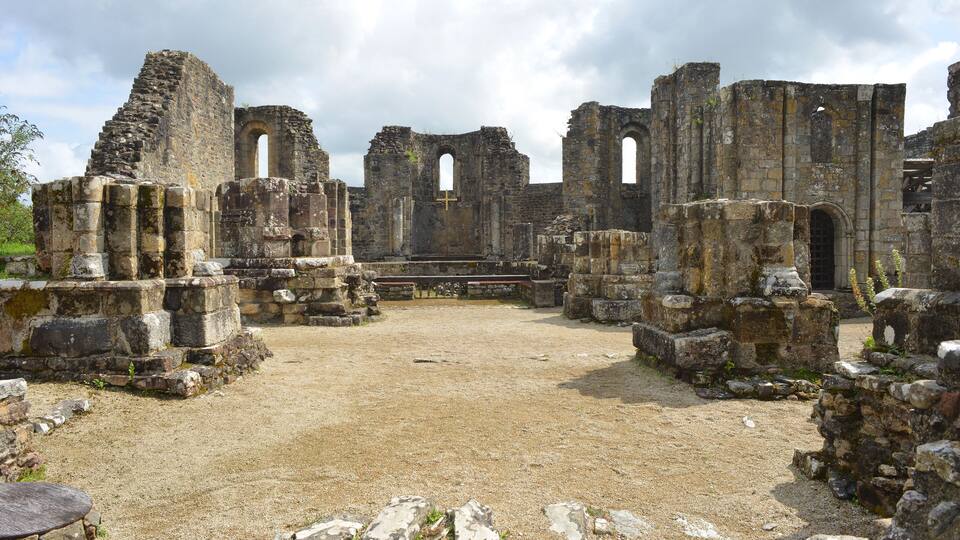 Ancient stone ruins with arches and walls.