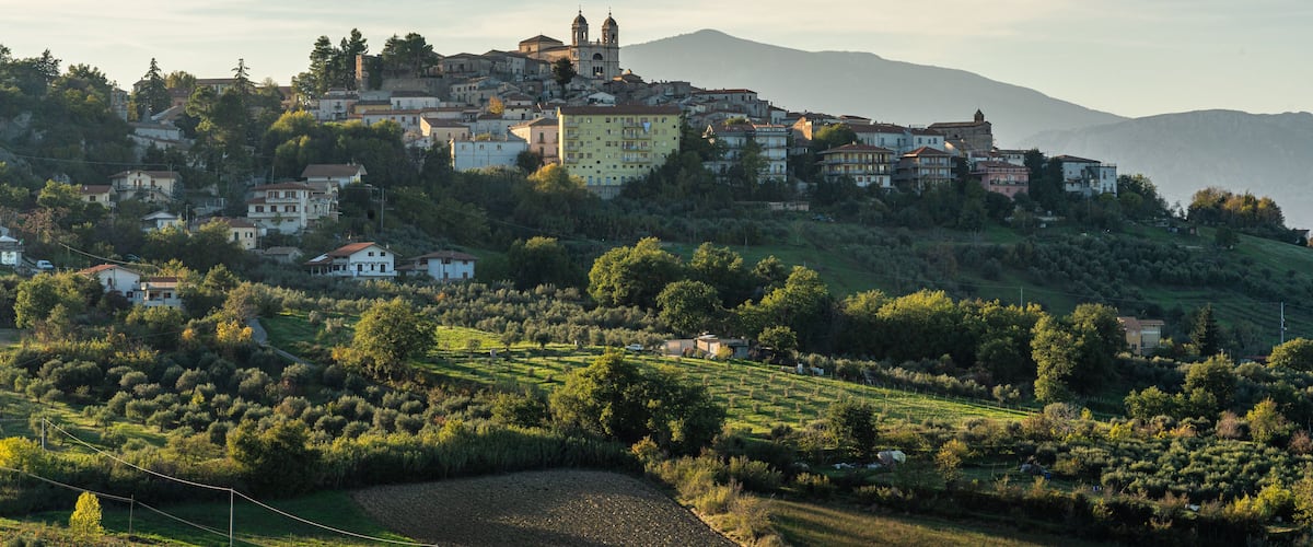 A hillside town with a prominent church and residential buildings.
