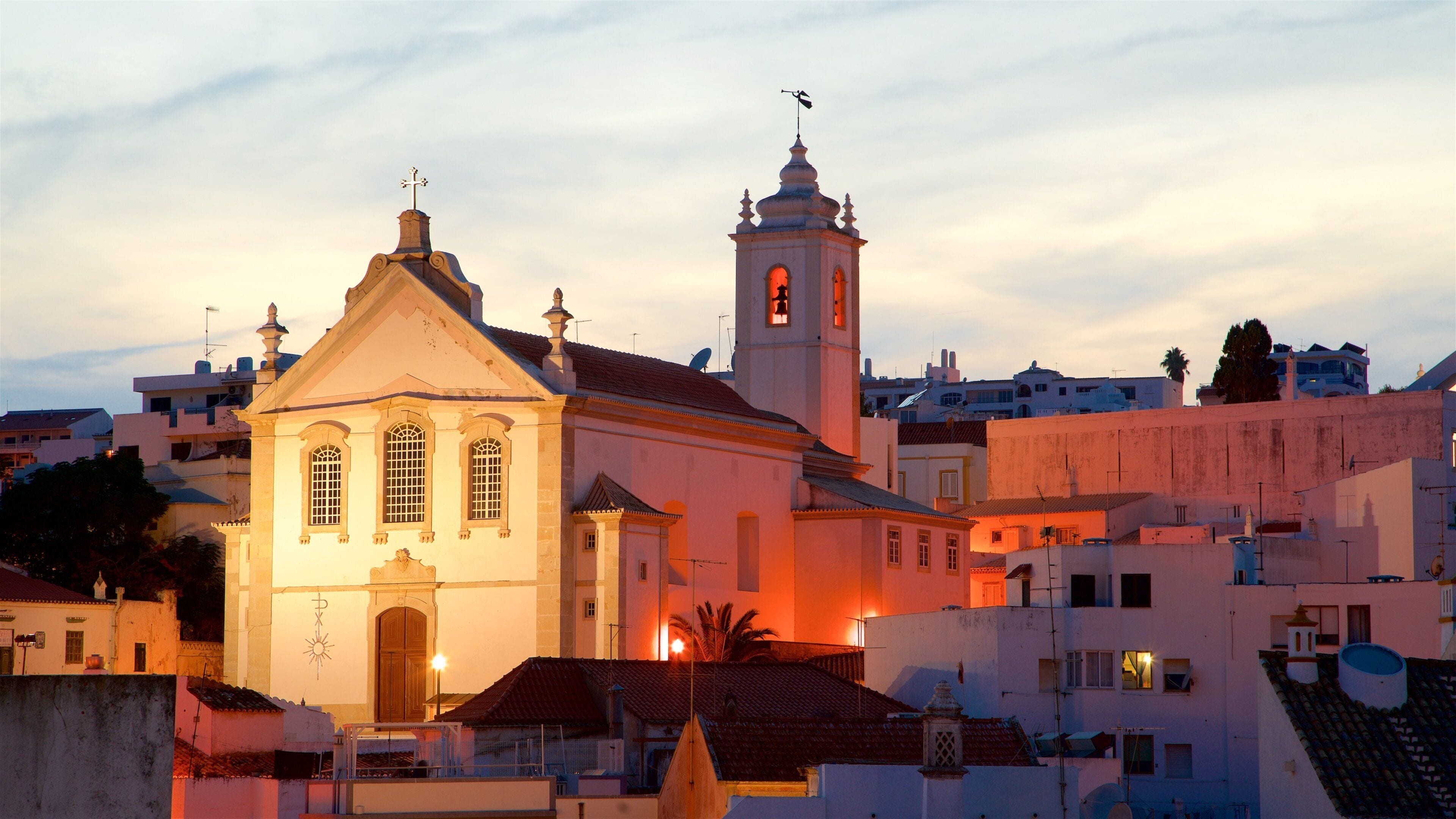 Albufeira Old Town Square showing a sunset and a church or cathedral