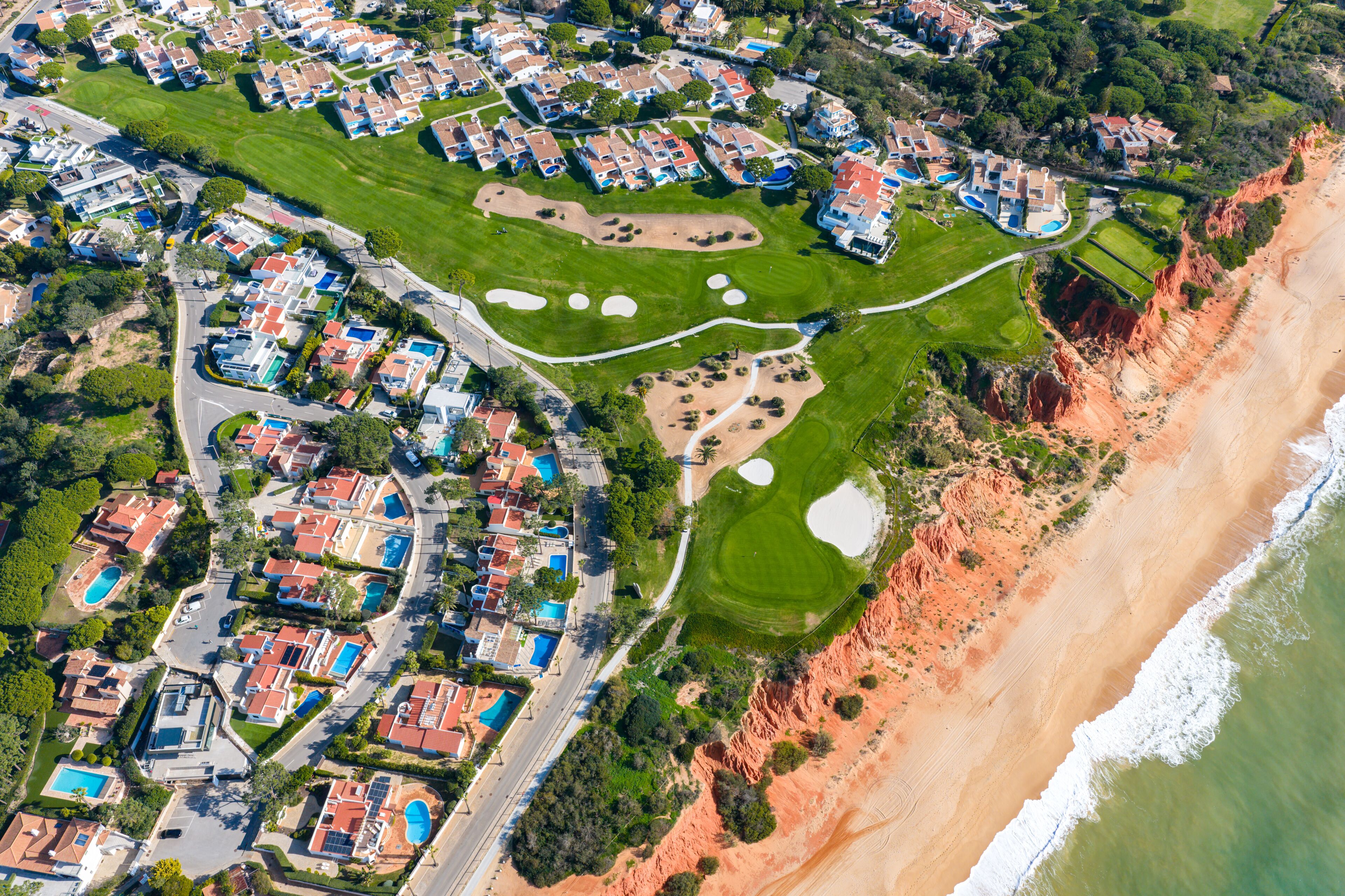 Luxury Living in the Golden Triangle: Cinematic 4K Aerial of Vale do Lobo Royal Golf Course and the Iconic Crimson Cliffs of Praia do Trafal, Algarve, Portugal