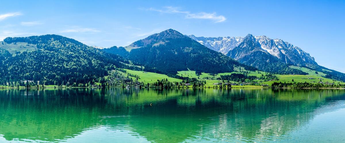 A mountain range with a lake reflecting the scenery.