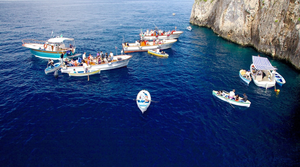 Blue Grotto which includes rugged coastline and boating as well as a small group of people