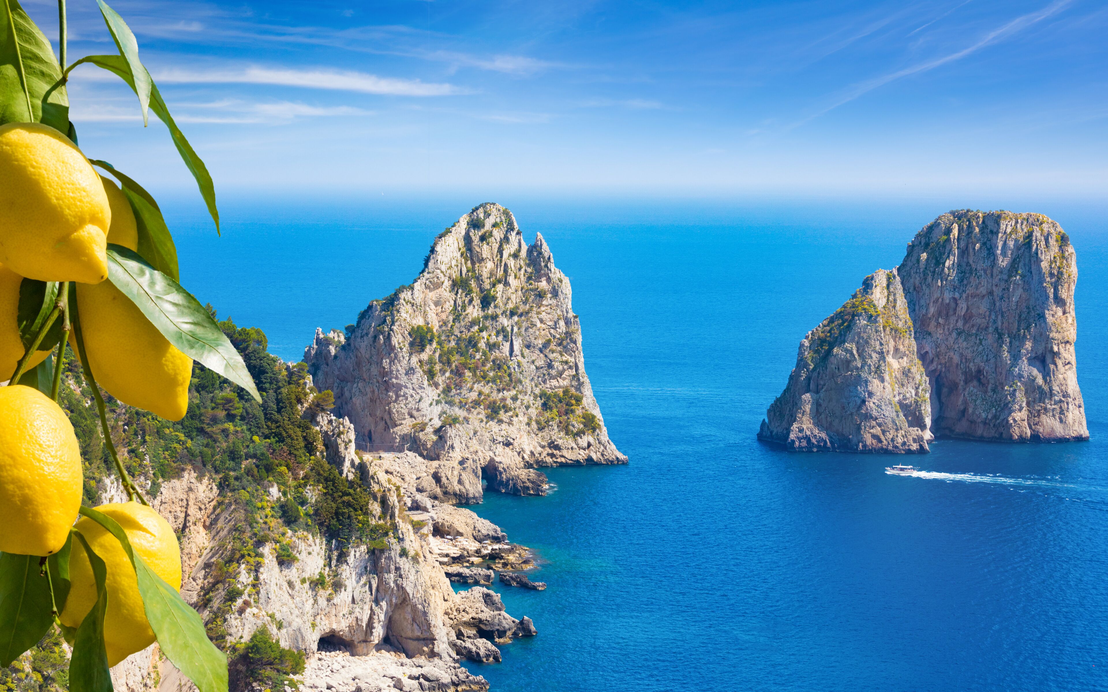 Daylight view of famous Faraglioni Rocks, Capri Island, Italy.